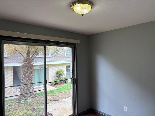 2020 Continental Ave Unit 120, Tallahassee, FL 32304 - doorway with baseboards and dark wood finished floors