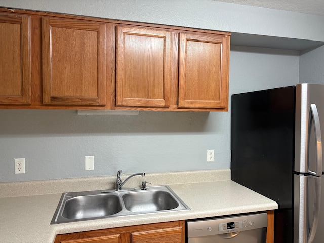 2020 Continental Ave Unit 120, Tallahassee, FL 32304 - kitchen featuring appliances with stainless steel finishes, light countertops, and brown cabinets