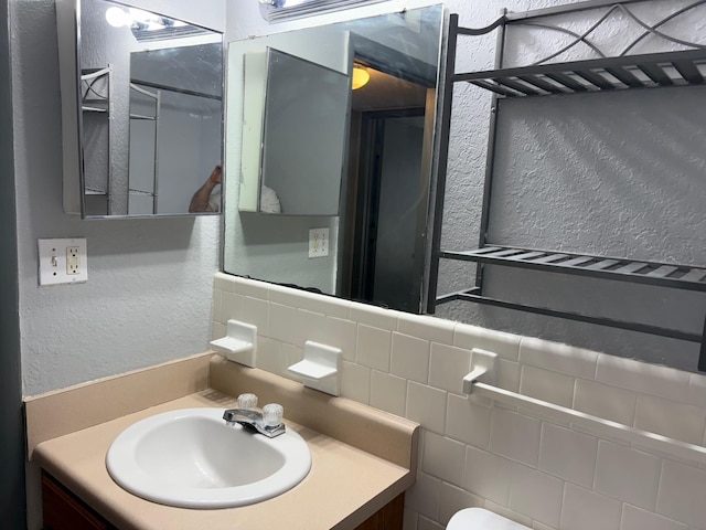 2020 Continental Ave Unit 120, Tallahassee, FL 32304 - half bath featuring vanity, a textured wall, and backsplash
