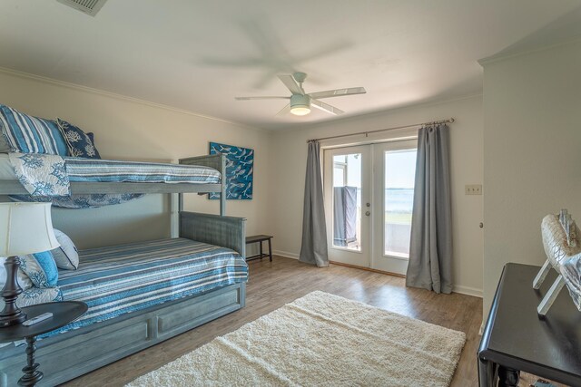 2433 Surf Rd, Panacea, FL 32346 - bedroom with access to exterior, baseboards, ornamental molding, wood finished floors, and ceiling fan