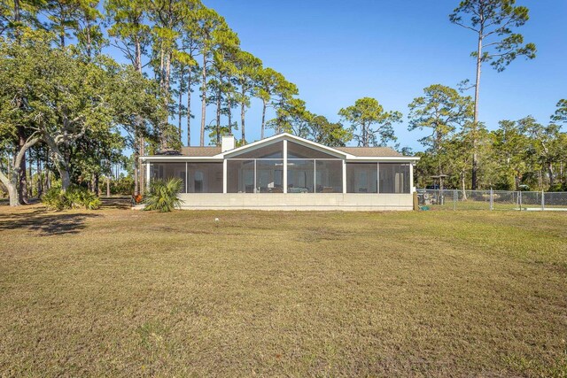 2433 Surf Rd, Panacea, FL 32346 - back of house featuring a sunroom and a chimney