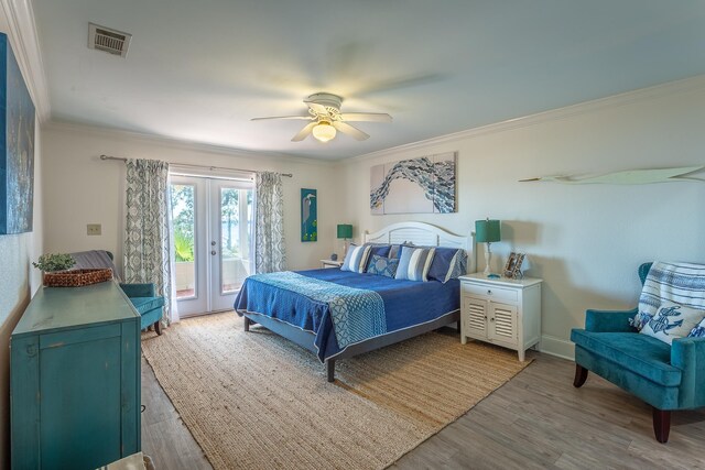 2433 Surf Rd, Panacea, FL 32346 - bedroom featuring access to outside, crown molding, wood finished floors, french doors, and ceiling fan
