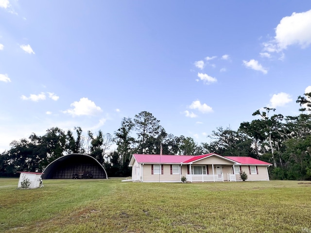 2048 W Gas Plant Rd, Perry, FL 32347 - view of front of property with a front yard, covered porch, a metal roof, and a detached carport