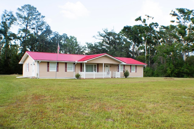 2048 W Gas Plant Rd, Perry, FL 32347 - ranch-style home with covered porch, a front yard, and a metal roof