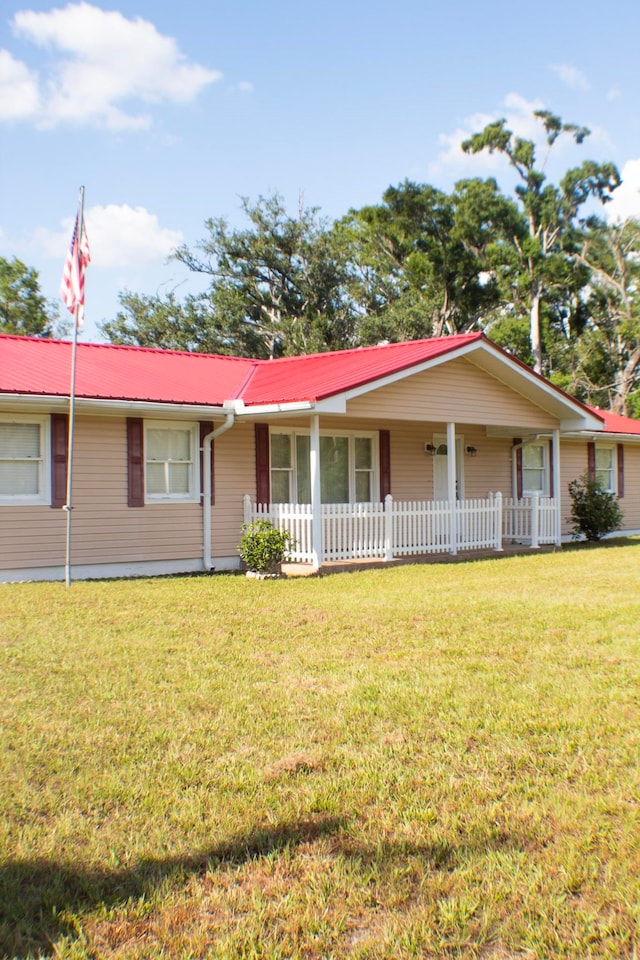 2048 W Gas Plant Rd, Perry, FL 32347 - single story home with a metal roof and a front lawn