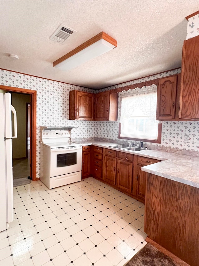 2048 W Gas Plant Rd, Perry, FL 32347 - kitchen featuring white appliances, wallpapered walls, light flooring, light countertops, and a textured ceiling