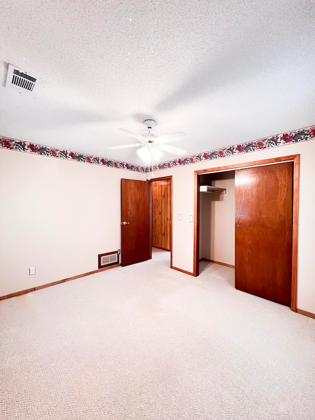 2048 W Gas Plant Rd, Perry, FL 32347 - unfurnished bedroom with light carpet, a textured ceiling, and a ceiling fan