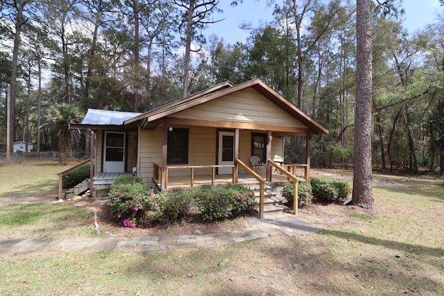 11350 Granny Ln, Tallahassee, FL 32305 - bungalow with metal roof, a front lawn, and covered porch