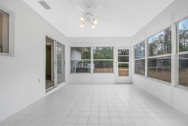 unfurnished sunroom featuring ceiling fan