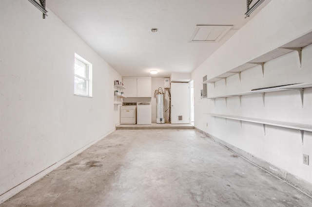 garage featuring water heater and independent washer and dryer