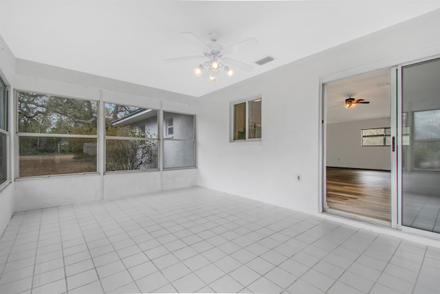 unfurnished sunroom with plenty of natural light and ceiling fan