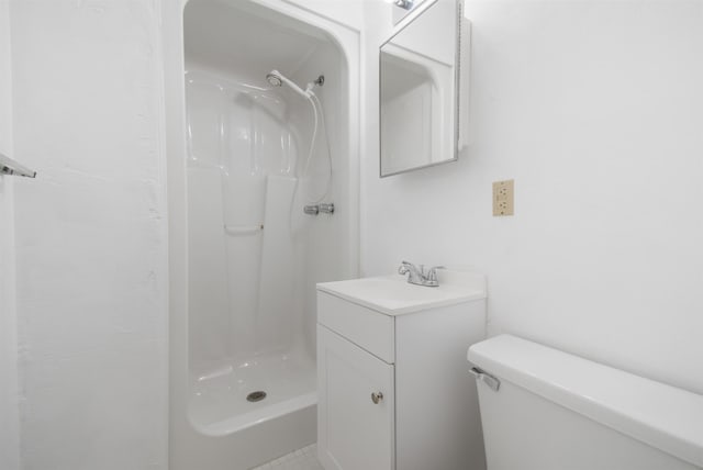 bathroom with vanity, toilet, and walk in shower