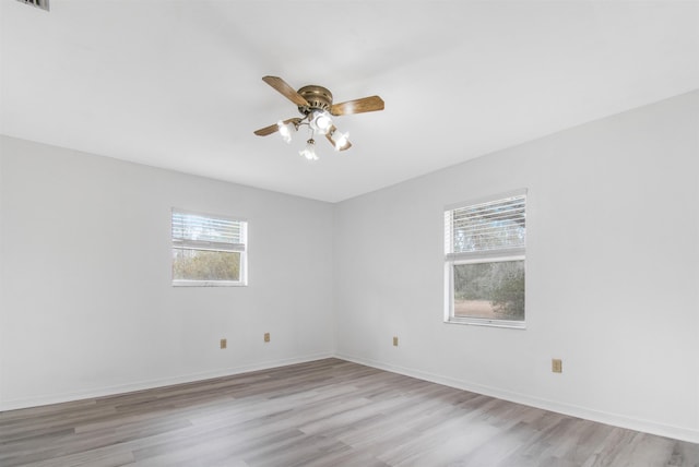 empty room with light hardwood / wood-style floors and ceiling fan