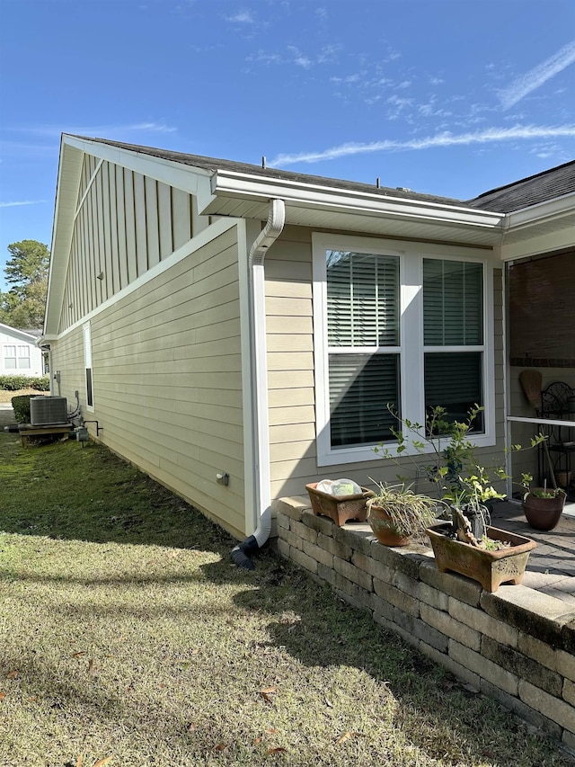 view of property exterior featuring a yard and central AC unit