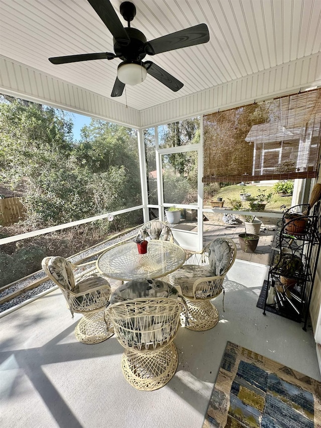 sunroom with a healthy amount of sunlight and ceiling fan