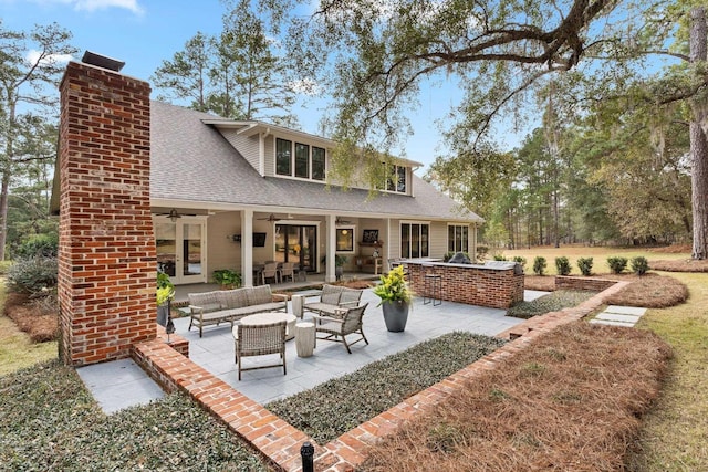 back of property featuring ceiling fan, an outdoor hangout area, and a patio area