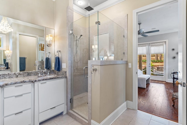 bathroom with ornamental molding, an enclosed shower, tile patterned flooring, and vanity