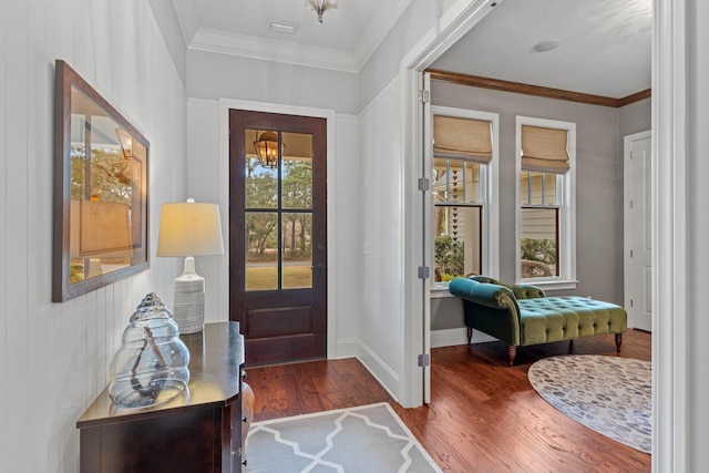 entryway with crown molding and dark hardwood / wood-style floors