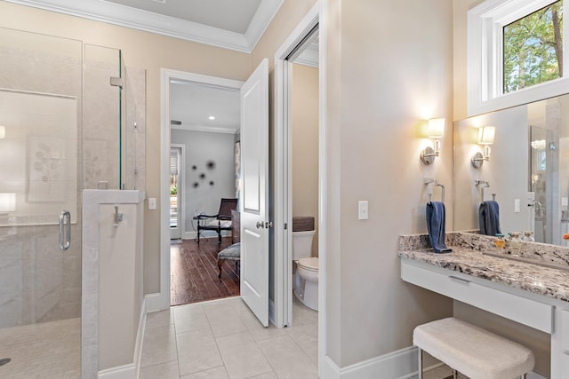 bathroom with walk in shower, toilet, crown molding, vanity, and tile patterned flooring