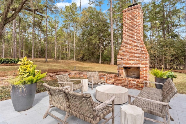 view of patio featuring an outdoor brick fireplace