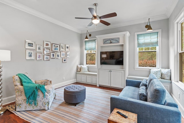 living room featuring hardwood / wood-style flooring, ornamental molding, and ceiling fan