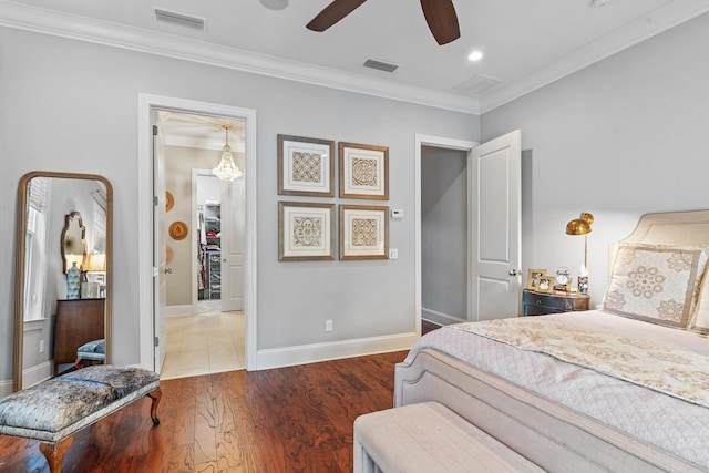 bedroom featuring crown molding, dark hardwood / wood-style floors, and ceiling fan