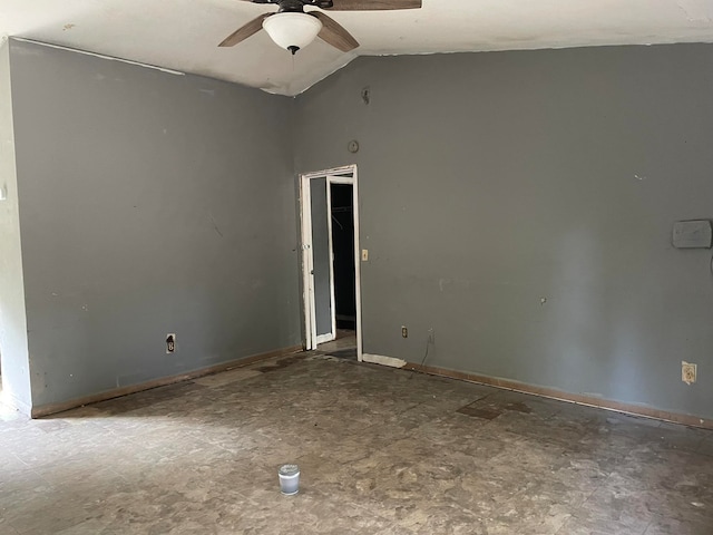 unfurnished room with ceiling fan and vaulted ceiling