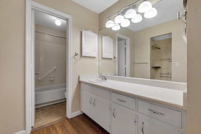 bathroom featuring bathing tub / shower combination, hardwood / wood-style floors, and vanity