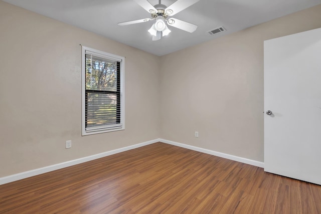 spare room featuring wood-type flooring and ceiling fan