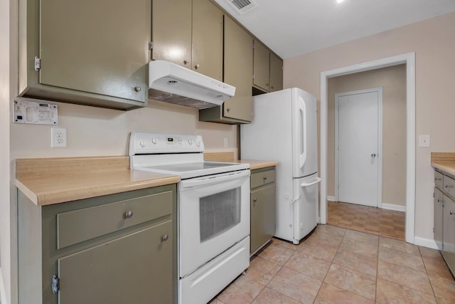 kitchen with light tile patterned flooring, white appliances, and green cabinetry