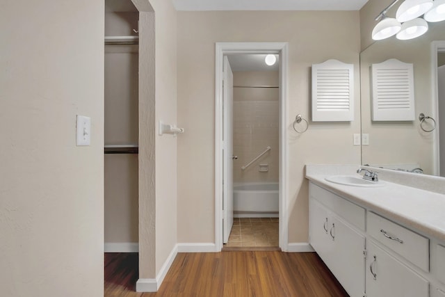 bathroom featuring vanity, wood-type flooring, and  shower combination