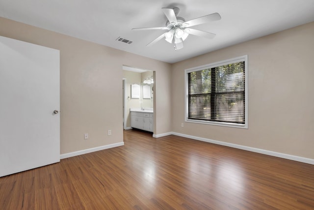 empty room with ceiling fan and wood-type flooring