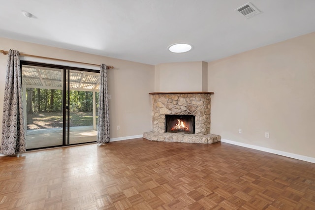 unfurnished living room with parquet floors and a fireplace