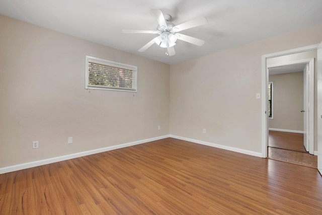 unfurnished room with ceiling fan and wood-type flooring