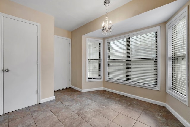 interior space featuring light tile patterned floors and a notable chandelier