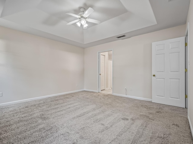 1 Black Foot Rd, Crawfordville, FL 32327 - unfurnished bedroom with a tray ceiling, carpet floors, and ceiling fan