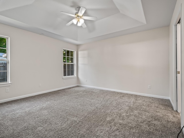 1 Black Foot Rd, Crawfordville, FL 32327 - carpeted empty room with a tray ceiling and ceiling fan