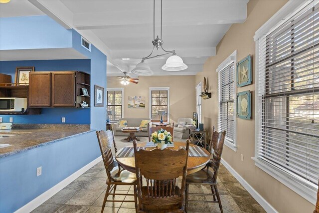 233 NE Maggie Cir, Steinhatchee, FL 32359 - dining area featuring beam ceiling, ceiling fan, baseboards, and stone tile floors