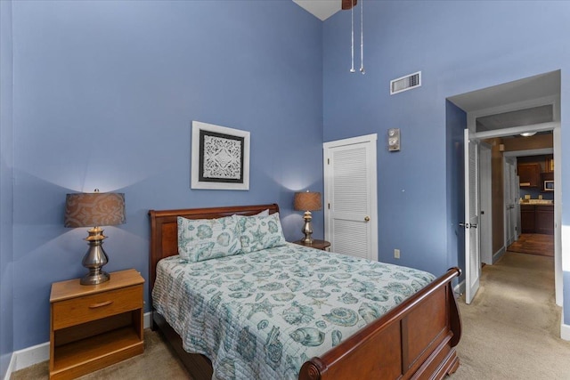 233 NE Maggie Cir, Steinhatchee, FL 32359 - bedroom featuring a towering ceiling, a closet, light carpet, and baseboards