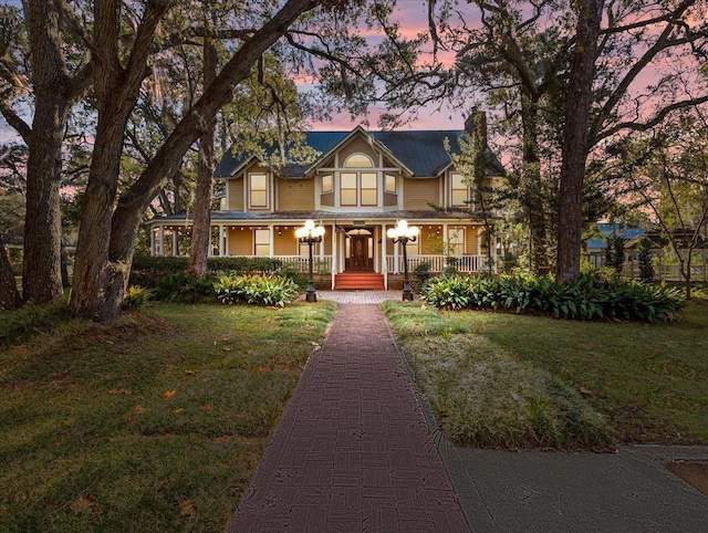 233 NE Maggie Cir, Steinhatchee, FL 32359 - victorian-style house with a porch and a yard