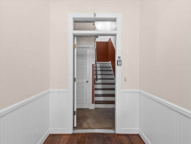 233 NE Maggie Cir, Steinhatchee, FL 32359 - staircase featuring a wainscoted wall and wood finished floors