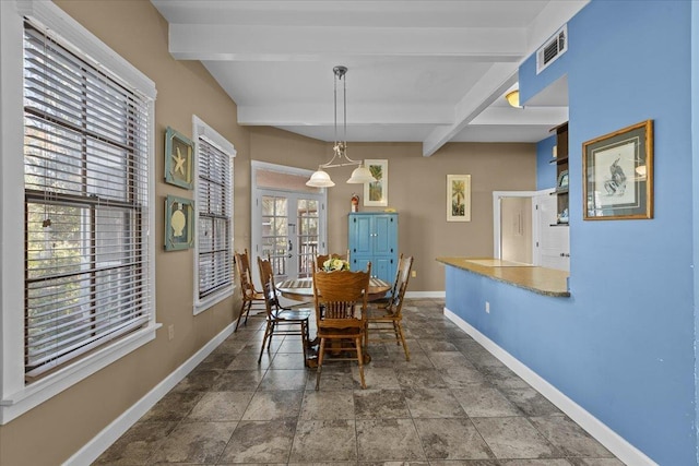 233 NE Maggie Cir, Steinhatchee, FL 32359 - dining space featuring baseboards, beam ceiling, and stone finish flooring