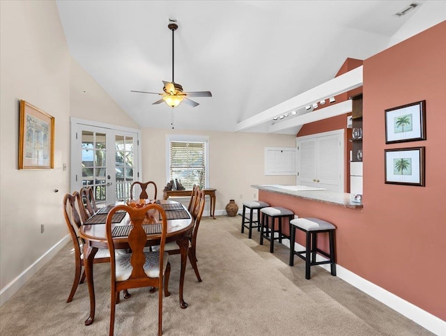233 NE Maggie Cir, Steinhatchee, FL 32359 - dining room featuring vaulted ceiling, baseboards, a ceiling fan, and light carpet
