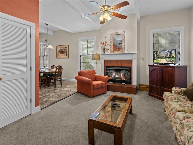 233 NE Maggie Cir, Steinhatchee, FL 32359 - carpeted living area featuring a ceiling fan, baseboards, beam ceiling, and a tile fireplace