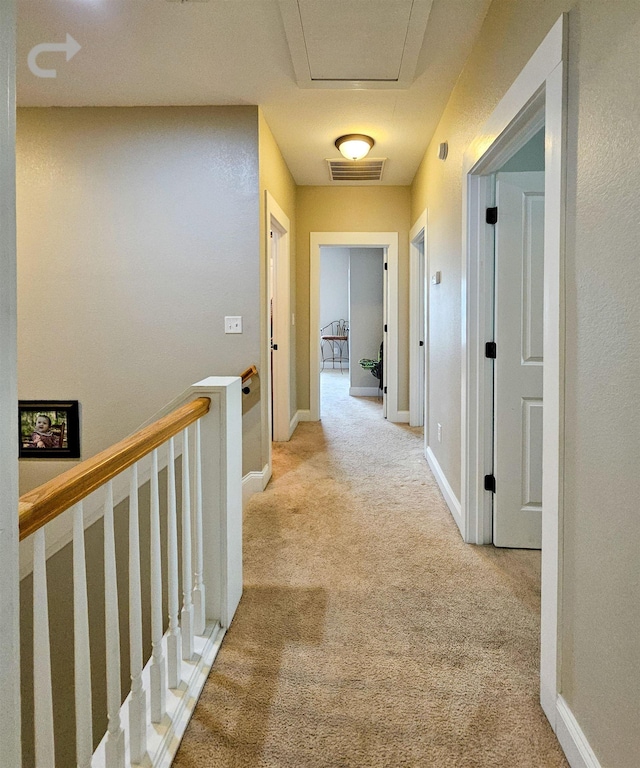 hallway with light colored carpet