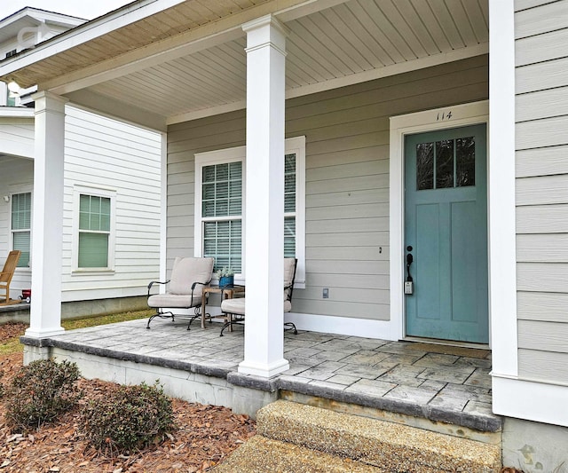 view of exterior entry featuring a porch