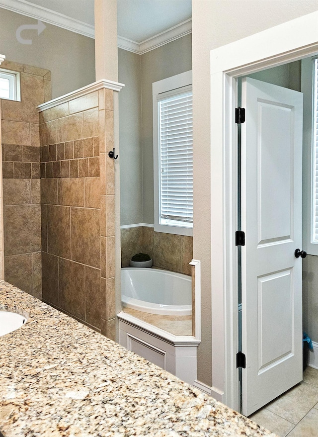 bathroom with crown molding, vanity, a bathtub, and tile patterned floors