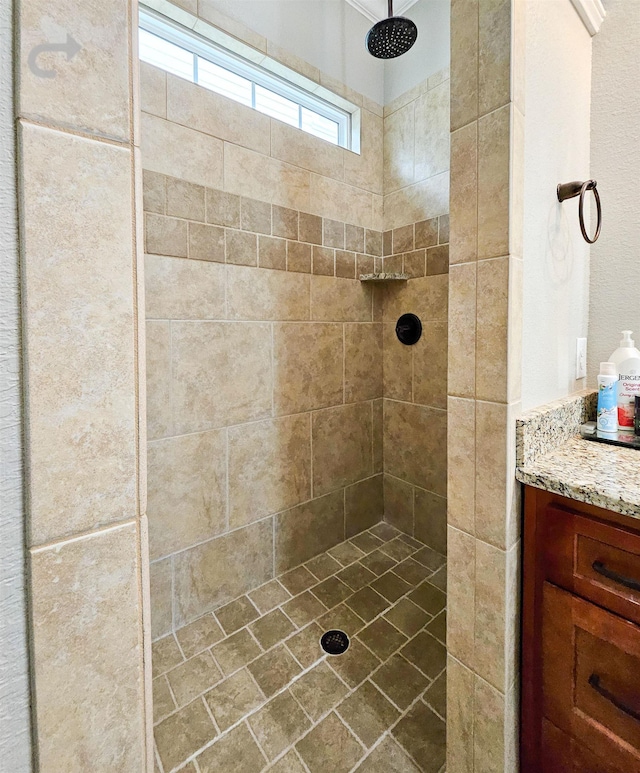 bathroom featuring vanity and a tile shower