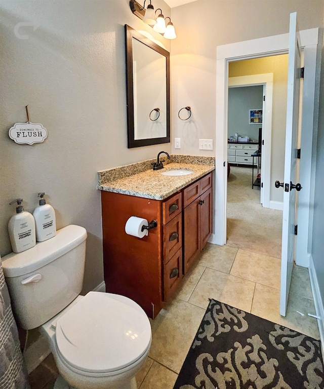 bathroom with vanity, tile patterned floors, and toilet