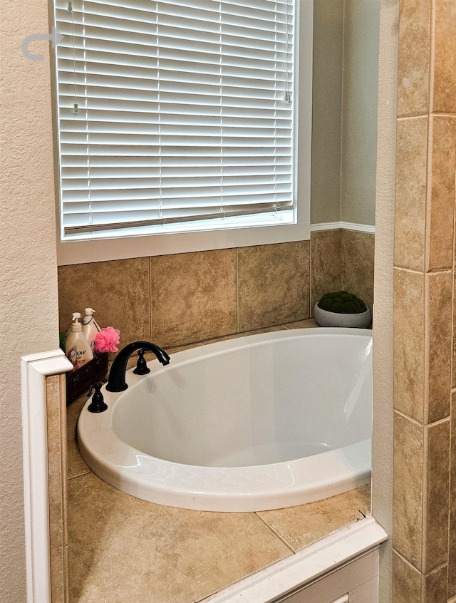 bathroom featuring a relaxing tiled tub